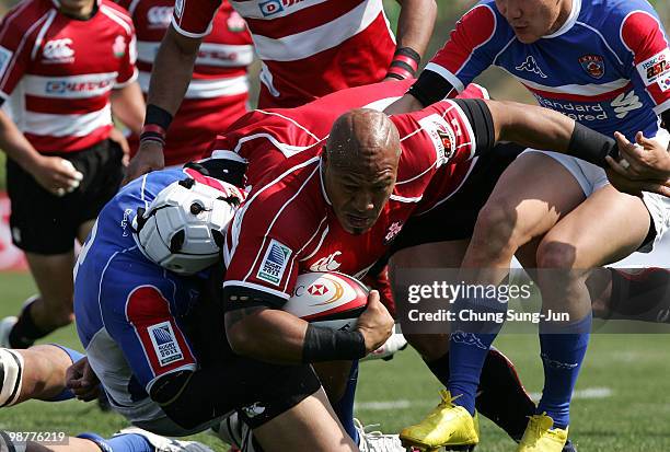 Alisi Tupuailei of Japan is tackled during the Rugby Asia 5 Nations & 2011 Rugby World Cup Qualifier between South Korea and Japan on May 1, 2010 in...