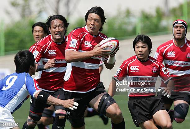 Toshizumi Kitagawa of Japan moves the ball up against South Korea during the Rugby Asia 5 Nations & 2011 Rugby World Cup Qualifier between South...