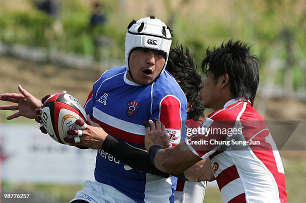 Choi Si-Won of South Korea is tackled during the Rugby Asia 5 Nations & 2011 Rugby World Cup Qualifier between South Korea and Japan on May 1, 2010...