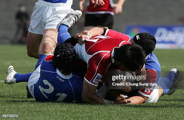 Yasunori Nagatomo of Japan is tackled during the Rugby Asia 5 Nations & 2011 Rugby World Cup Qualifier between South Korea and Japan on May 1, 2010...