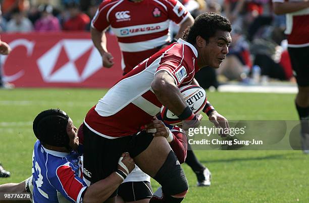 Touetsu Taufa of Japan is tackled during the Rugby Asia 5 Nations & 2011 Rugby World Cup Qualifier between South Korea and Japan on May 1, 2010 in...