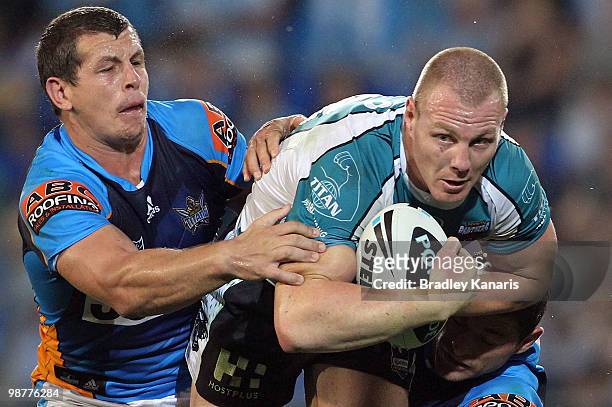 Luke Lewis of the Panthers attempts to break through the Titans defence during the round eight NRL match between the Gold Coast Titans and the...