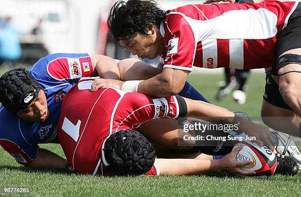 Hisateru Hirashima of Japan is tackled during the Rugby Asia 5 Nations & 2011 Rugby World Cup Qualifier between South Korea and Japan on May 1, 2010...