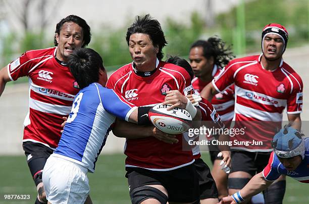 Toshizumi Kitagawa of Japan is tackled during the Rugby Asia 5 Nations & 2011 Rugby World Cup Qualifier between South Korea and Japan on May 1, 2010...