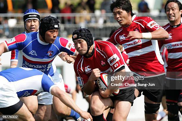 Hisateru Hirashima of Japan moves the ball up against South Korea during the Rugby Asia 5 Nations & 2011 Rugby World Cup Qualifier between South...
