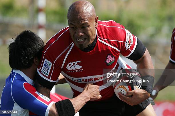 Alisi Tupuailei of Japan is tackled during the Rugby Asia 5 Nations & 2011 Rugby World Cup Qualifier between South Korea and Japan on May 1, 2010 in...