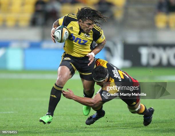 Ma'a Nonu of the Hurricanes is tackled by Tanerau Latimer of the Chiefs during the round 12 Super 14 match between the Hurricanes and the Chiefs at...