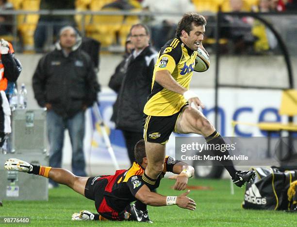 Conrad Smith of the Hurricanes is tackled by Tim Nanai-Williams of the Chiefs during the round 12 Super 14 match between the Hurricanes and the...