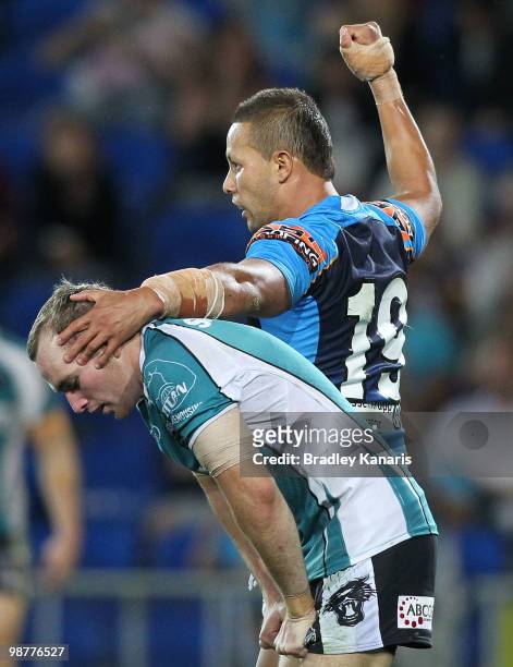 Scott Prince of the Titans pats Lule Walsh of the Panthers on the head after assisting in a try to team mate Ashley Harrison during the round eight...
