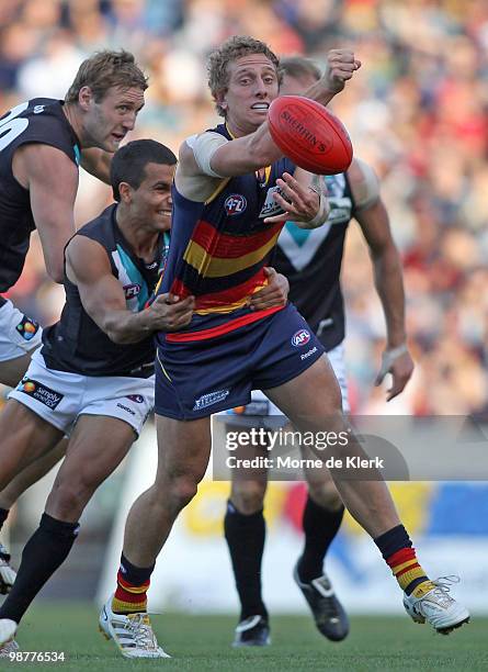 Chris Schmidt of the Crows gets a pass away under pressure during the round six AFL match between the Adelaide Crows and the Port Adelaide Power at...