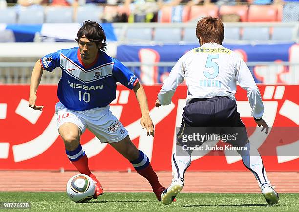Koji Yamase of Yokohama F. Marinos and Yuichi Komano of Jubilo Iwata compete for the ball during the J. League match between Yokohama F. Marinos and...