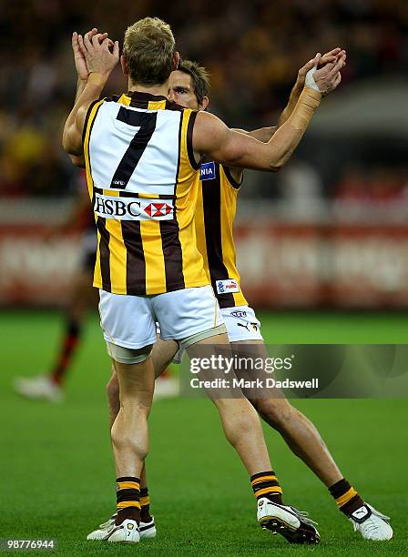 Michael Osborne of the Hawks is congratulated by Chance Bateman during the round 6 AFL match between the Essendon Bombers and the Hawthorn Hawks at...