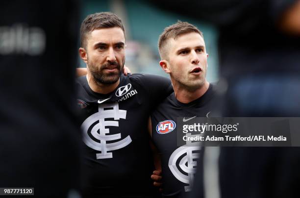 Kade Simpson of the Blues listens in before his 300th match to captain Marc Murphy of the Blues during the 2018 AFL round 15 match between the...