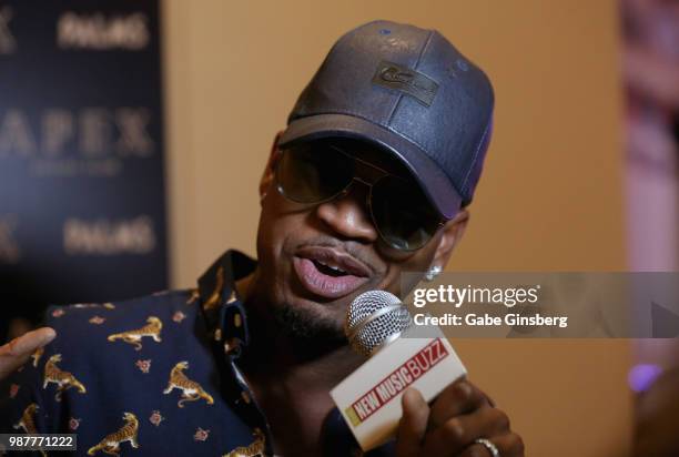 Singer/songwriter Ne-Yo speaks with an interviewer during the release party for his seventh studio album "Good Man" at Apex Social Club at Palms...