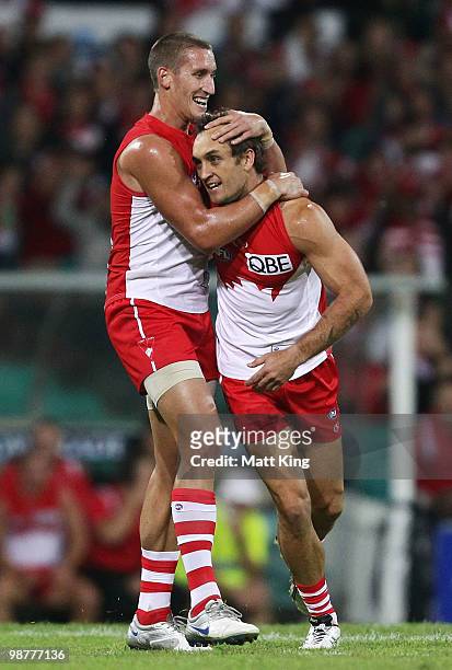 Daniel Bradshaw of the Swans celebrates with Jesse White after scoring a goal during the round six AFL match between the Sydney Swans and the...