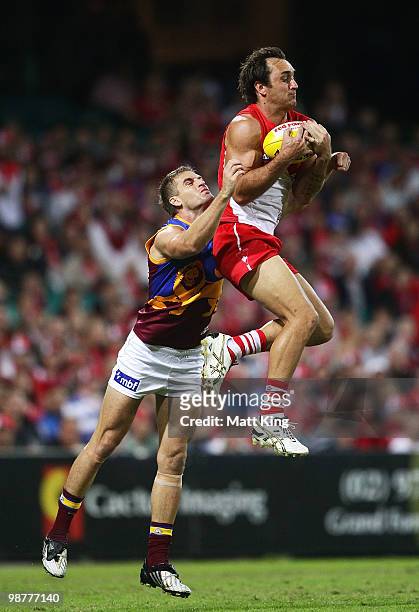Daniel Bradshaw of the Swans marks in front of Josh Drummond of the Lions during the round six AFL match between the Sydney Swans and the Brisbane...