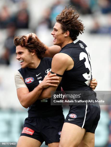 Charlie Curnow of the Blues celebrates a goal with Cameron Polson of the Blues during the 2018 AFL round 15 match between the Carlton Blues and the...