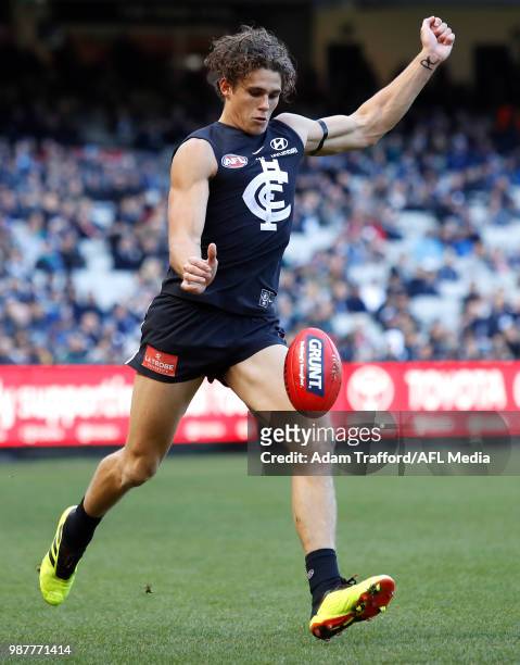 Charlie Curnow of the Blues kicks the ball during the 2018 AFL round 15 match between the Carlton Blues and the Port Adelaide Power at the Melbourne...