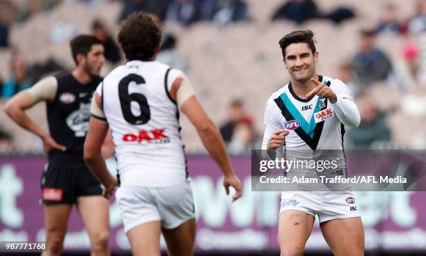 Chad Wingard of the Power celebrates a goal with Steven Motlop of the Power during the 2018 AFL round 15 match between the Carlton Blues and the Port...