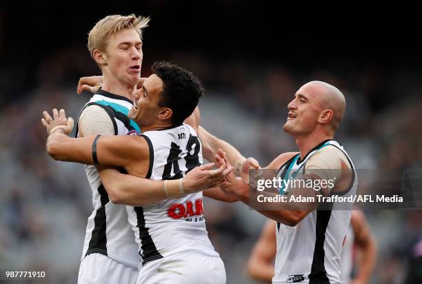 Todd Marshall of the Power celebrates a goal with Lindsay Thomas and Sam Powell-Pepper of the Power during the 2018 AFL round 15 match between the...