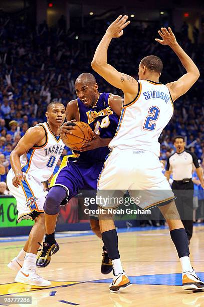 Kobe Bryant of the Los Angeles Lakers goes hard to the hoop against Russelll Westbrook and Thabo Sefilosha of the Oklahoma City Thunder in Game Six...
