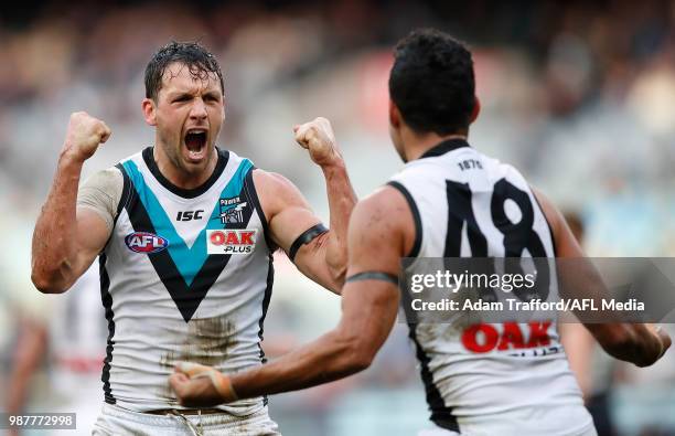 Travis Boak of the Power celebrates a goal with Lindsay Thomas of the Power during the 2018 AFL round 15 match between the Carlton Blues and the Port...