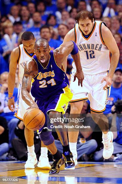 Kobe Bryant of the Los Angeles Lakers drives up court as Nenad Krstic and Russell Westbrook of the Oklahoma City Thunder look on in Game Six of the...