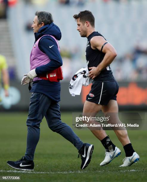 Matthew Wright of the Blues leaves the field after a knock during the 2018 AFL round 15 match between the Carlton Blues and the Port Adelaide Power...