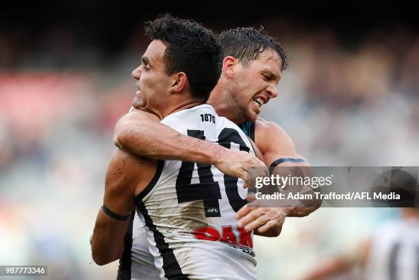 Travis Boak of the Power celebrates a goal with Lindsay Thomas of the Power during the 2018 AFL round 15 match between the Carlton Blues and the Port...