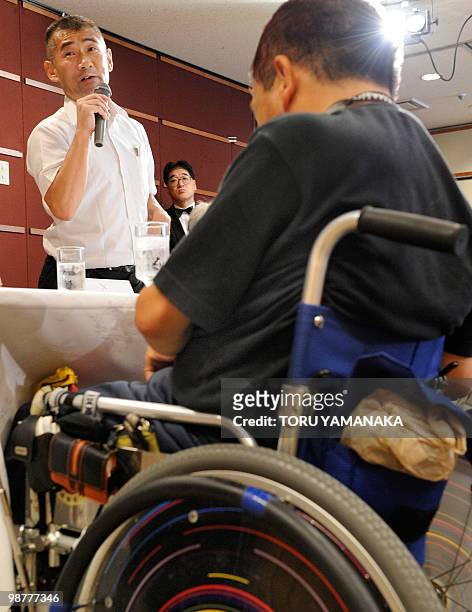 Minamata disease patient Kenji Nagamoto stands beside other patients as he criticizes a bill during a press conference in Tokyo on July 8, 2009....
