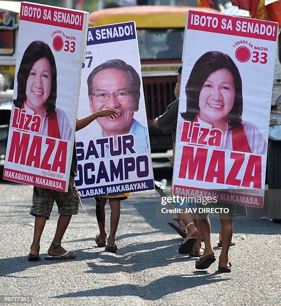 Children carry political posters of left wing law makers running to be elected as senators, during a Labour Day march that turned into an election...