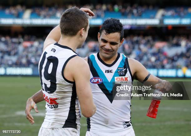 Jack Trengove of the Power celebrates his first win for the club with Lindsay Thomas of the Power during the 2018 AFL round 15 match between the...