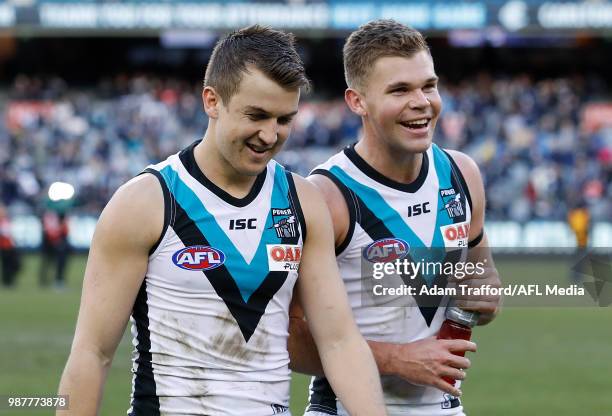 Jack Trengove of the Power celebrates his first win for the club with Dan Houston of the Power during the 2018 AFL round 15 match between the Carlton...