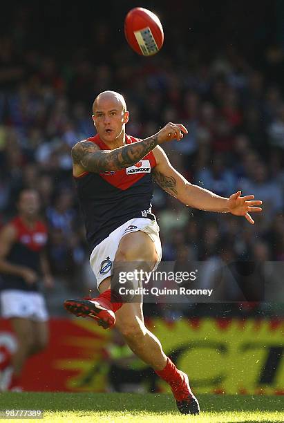 Nathan Jones of the Demons kicks during the round six AFL match between the North Melbourne Kangaroos and the Melbourne Demons at Etihad Stadium on...