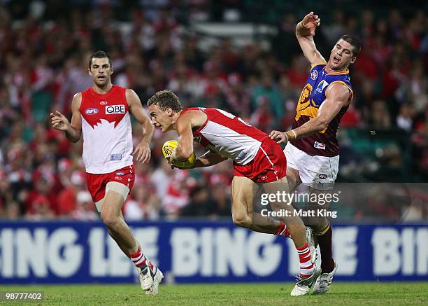 Ted Richards of the Swans marks in front of Jonathan Brown of the Lions during the round six AFL match between the Sydney Swans and the Brisbane...