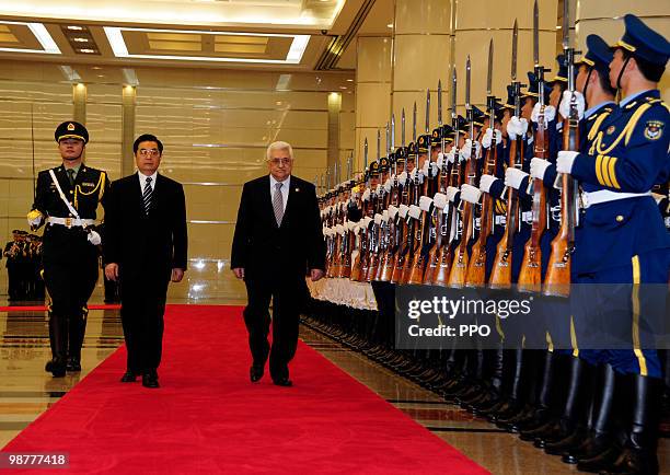 Chinese President Hu Jintao and Palestinian President Mahmoud Abbas review an honour guard during a welcoming ceremony prior to their meeting on May...