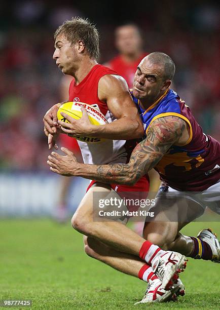 Kieren Jack of the Swans is tackled by Ashley McGrath of the Lions during the round six AFL match between the Sydney Swans and the Brisbane Lions at...