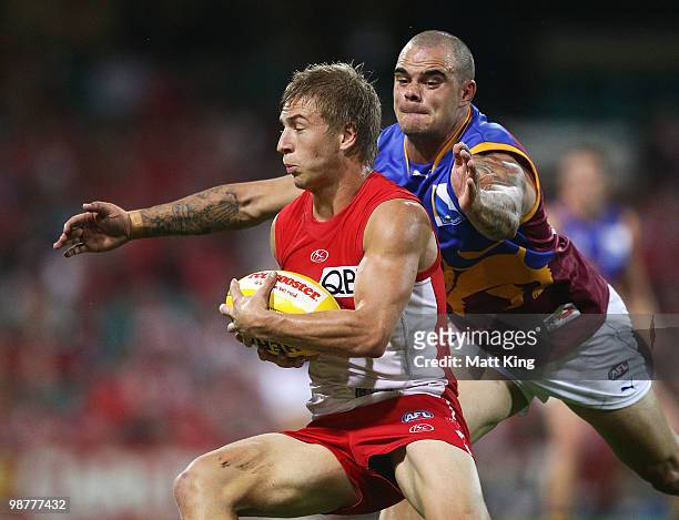 Kieren Jack of the Swans is tackled by Ashley McGrath of the Lions during the round six AFL match between the Sydney Swans and the Brisbane Lions at...