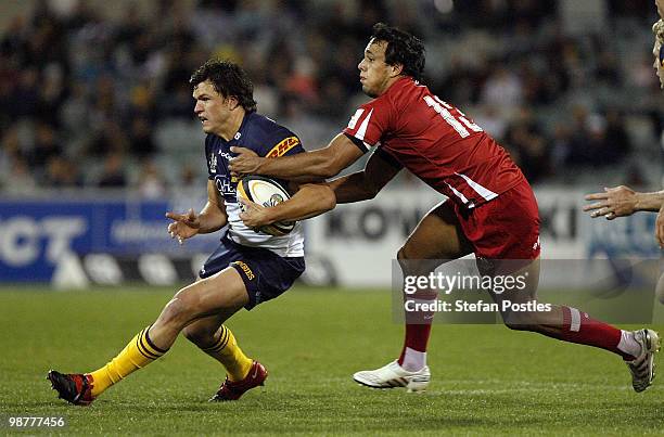 Adam Ashley-Cooper of the Brumbies is tackled by Will Chambers of the Reds during the round 12 Super 14 match between the Brumbies and the Reds at...