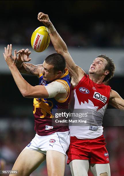 Jude Bolton of the Swans spoils a mark by Mitch Clark of the Lions during the round six AFL match between the Sydney Swans and the Brisbane Lions at...