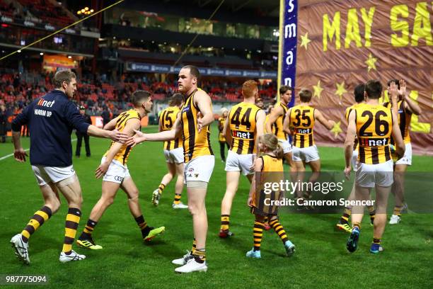 Jarryd Roughead of the Hawks enters the field with team mates during the round 15 AFL match between the Greater Western Sydney Giants and the...