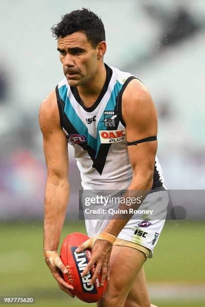 Lindsay Thomas of the Power kicks during the round 15 AFL match between the Carlton Blues and the Port Adelaide Power at Melbourne Cricket Ground on...