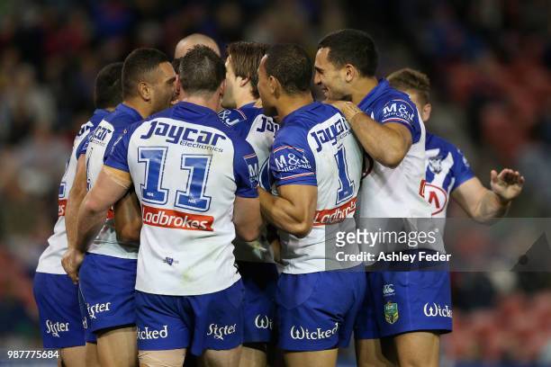 Fa'amanu Brown of the Bulldogs celebrates his try with team mates during the round 16 NRL match between the Newcastle Knights and the Canterbury...