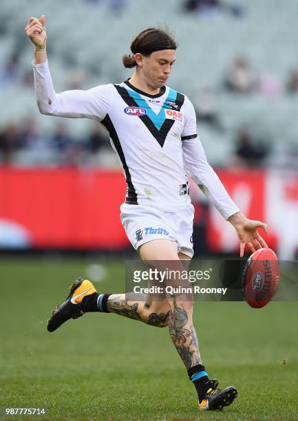 Jasper Pittard of the Power kicks during the round 15 AFL match between the Carlton Blues and the Port Adelaide Power at Melbourne Cricket Ground on...