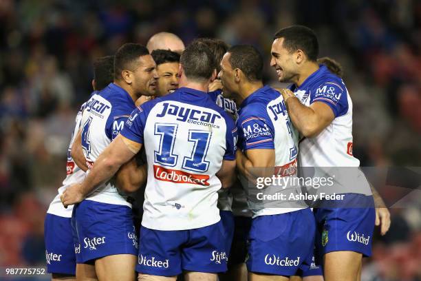 Fa'amanu Brown of the Bulldogs celebrates his try with team mates during the round 16 NRL match between the Newcastle Knights and the Canterbury...