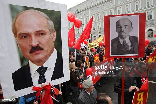 Supporters of the Russian Communist party and workers holding portraits of Belarus President Alexander Lukashenko and of former Bolchevik leader...