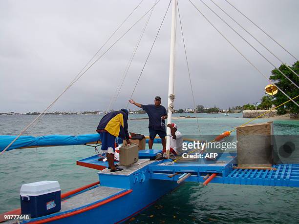 Marshalls-history-canoe" by Chris Foley This picture taken on April 29, 2010 shows Alson Kelen and crew readying the outrigger canoe Jitdam Kabeel,...