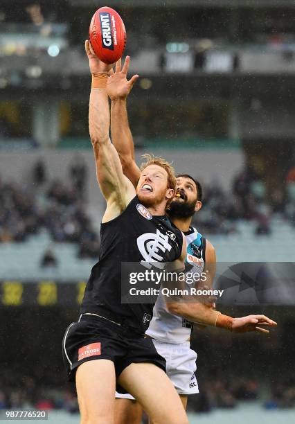 Andrew Phillips of the Blues and Patrick Ryder of the Power compete in the ruck during the round 15 AFL match between the Carlton Blues and the Port...