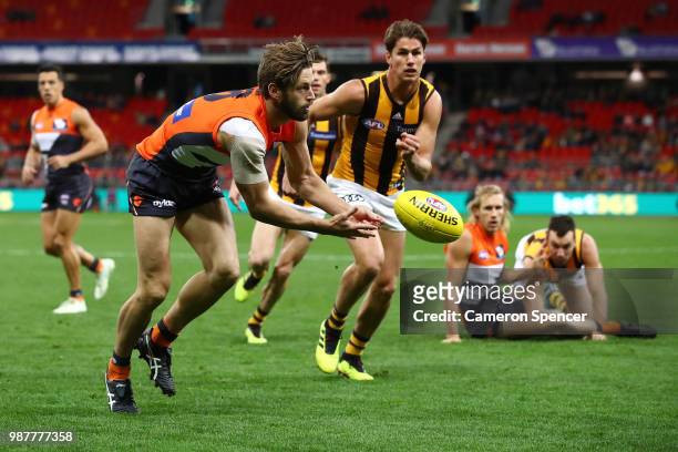 Callan Ward of the Giants handpasses during the round 15 AFL match between the Greater Western Sydney Giants and the Hawthorn Hawks at Spotless...