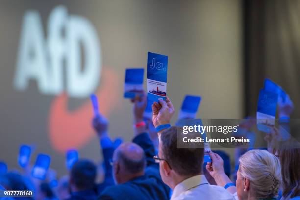 Delegates of the right-wing Alternative for Germany political party cast their votes during the AfD federal congress on June 30, 2018 in Augsburg,...